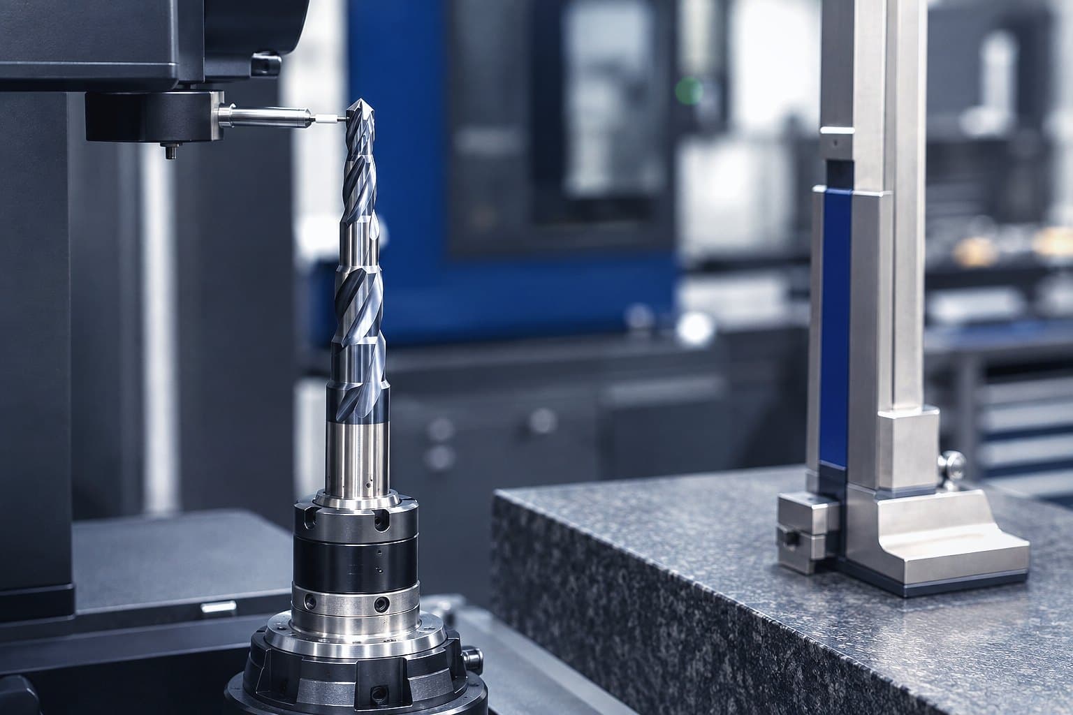 A stepped carbide special drill held on a tool measuring machine beside a height gauge